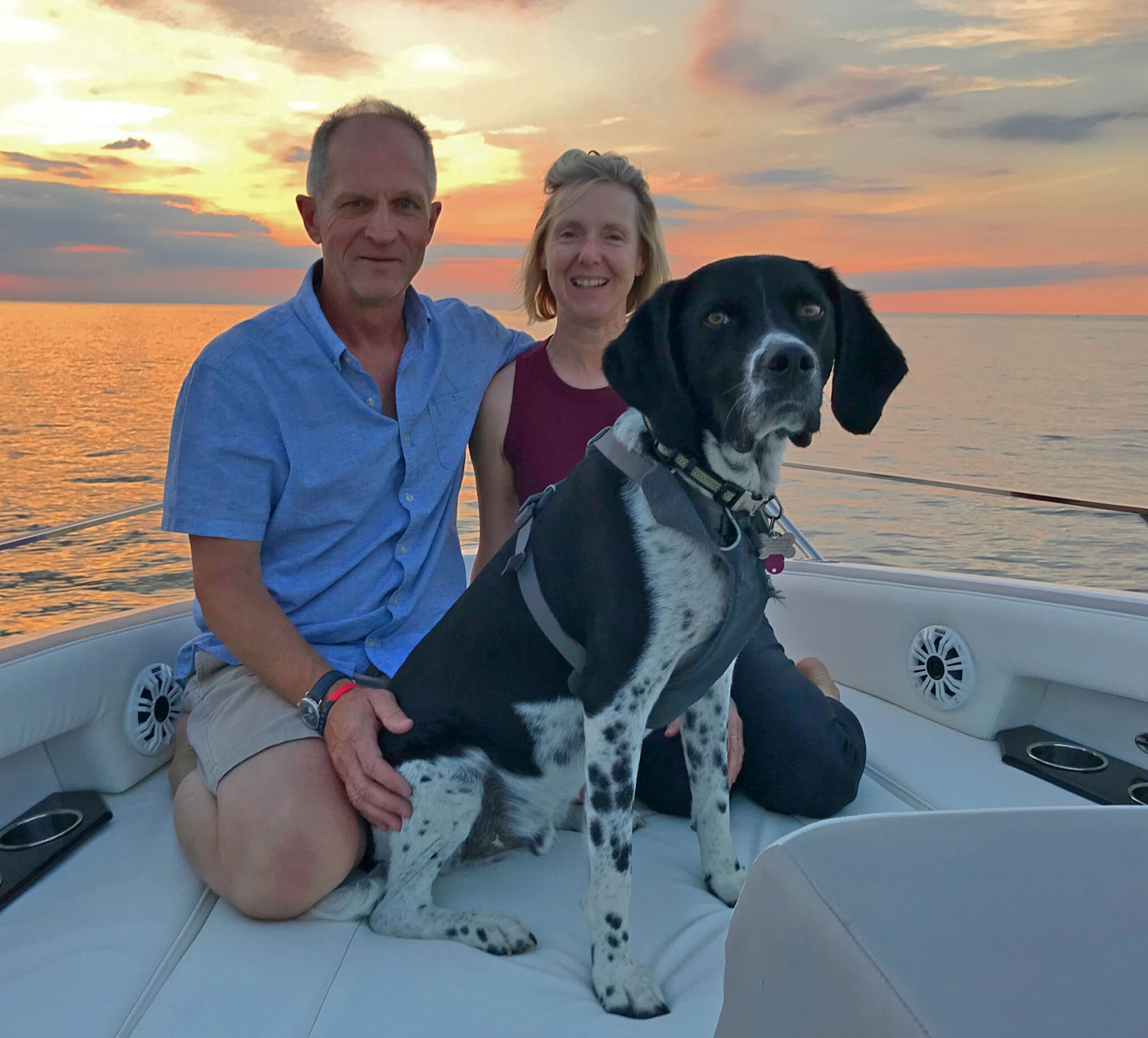 people and dog in boat