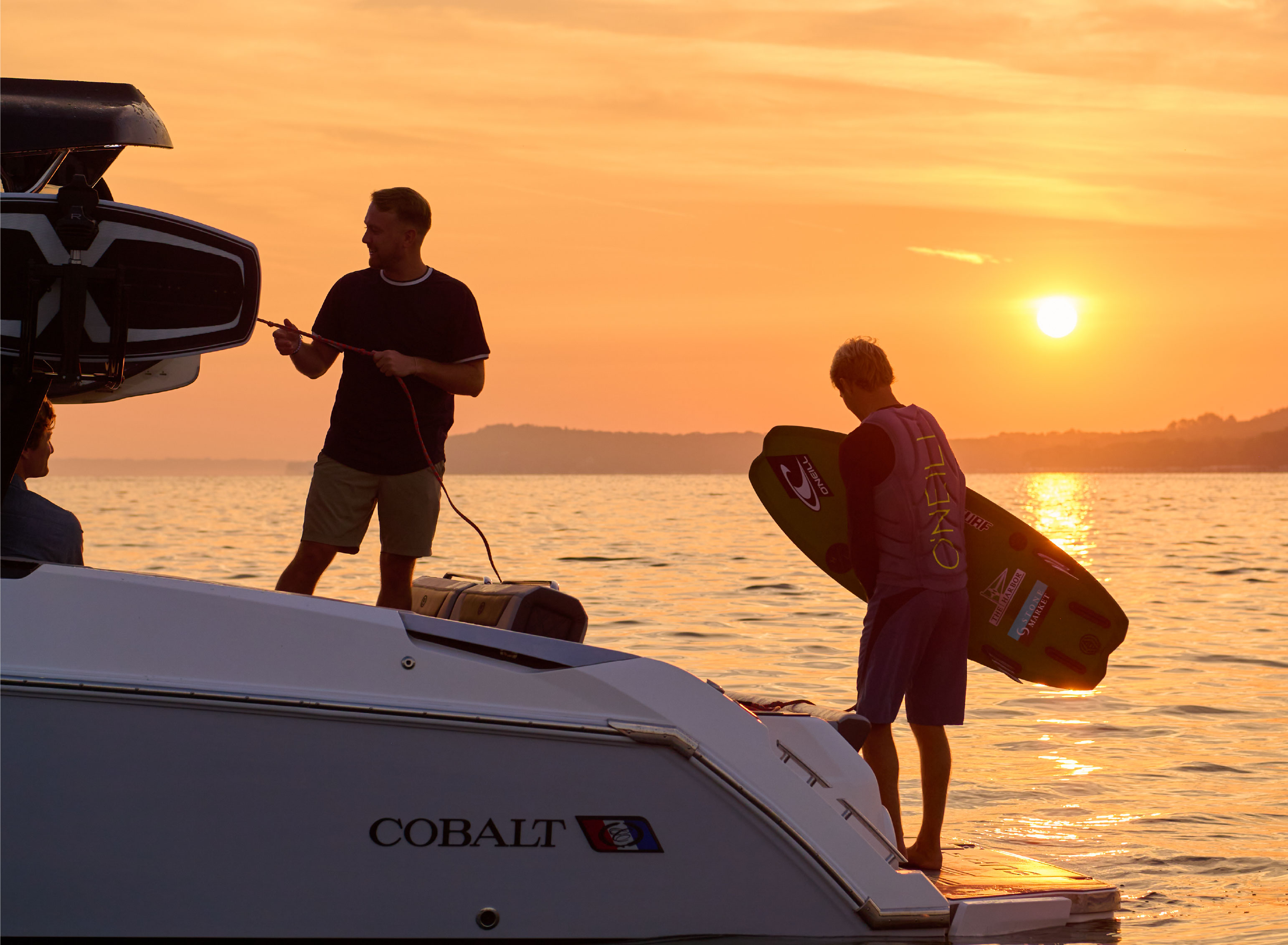 Guys getting off boat to surf