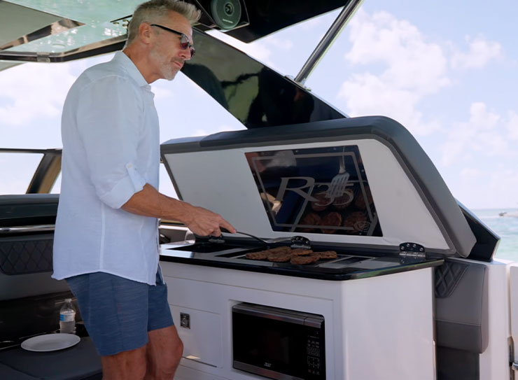 man grilling on boat
