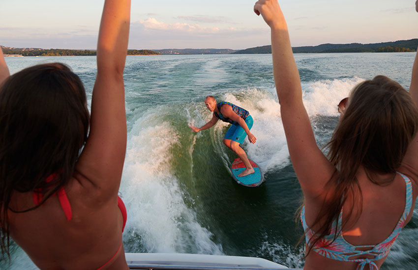 women watching man surf
