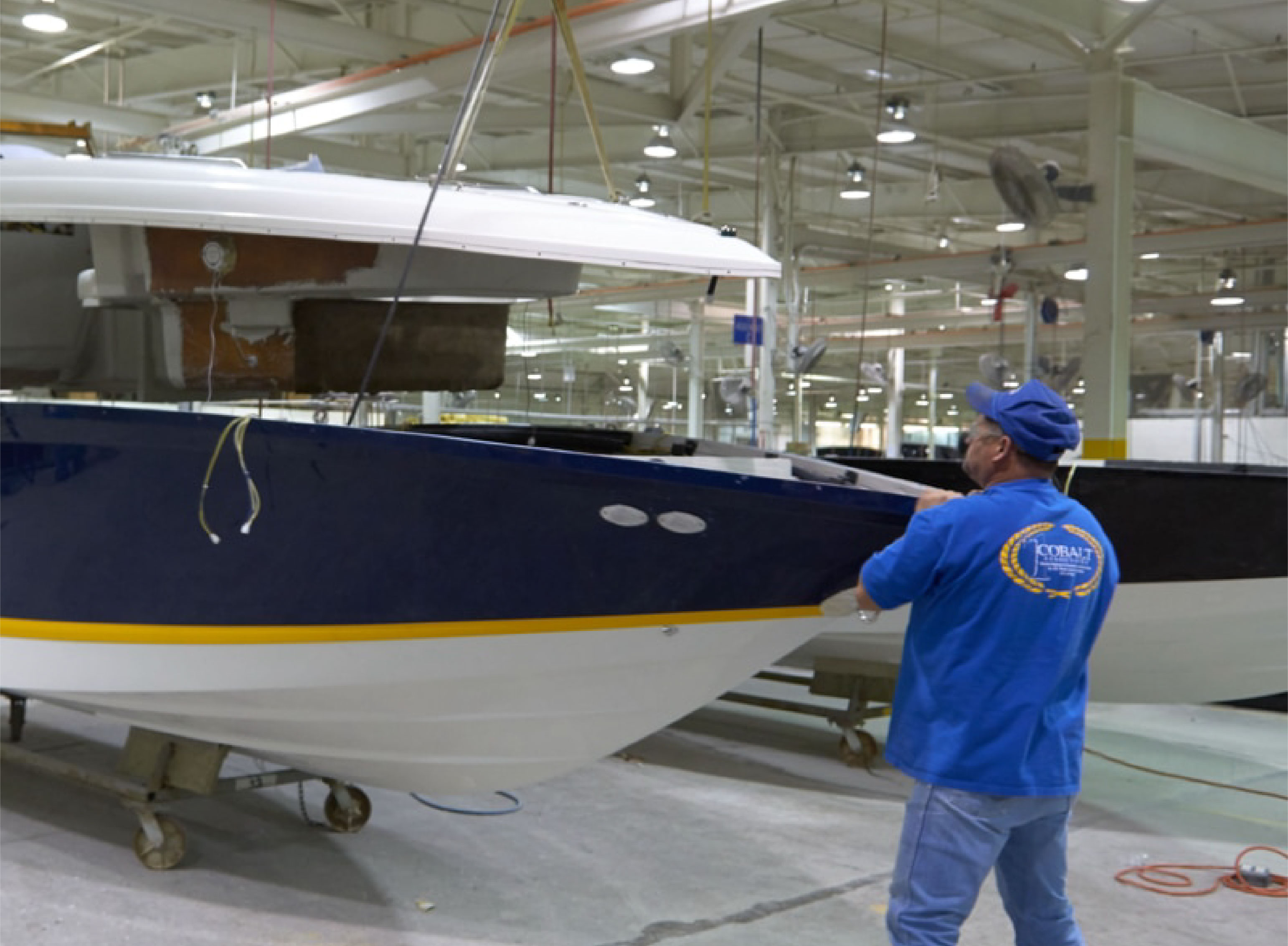 person in warehouse walking towards a boat