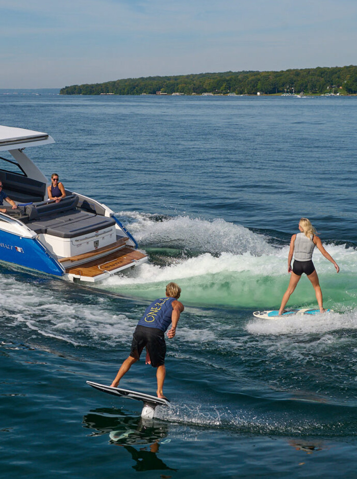 Surf Class Cobalt boat with people surfing