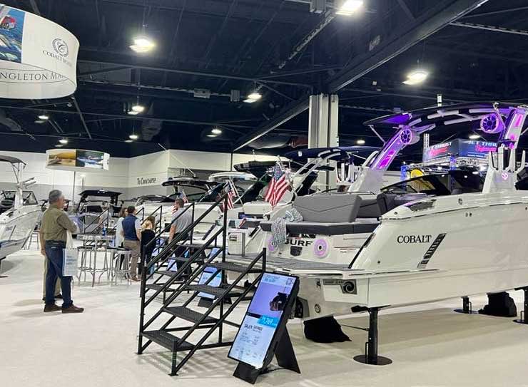 people looking at display boats
