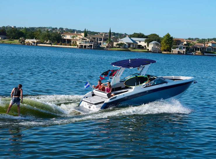 man being surfing behind boat
