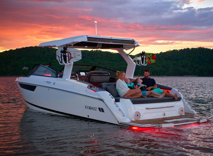 family enjoying sunset on boat