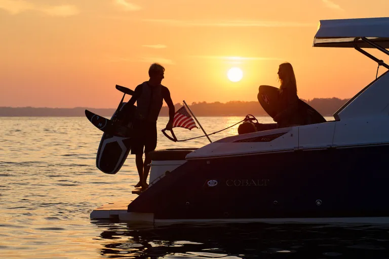person in a boat and a person about to go surfing