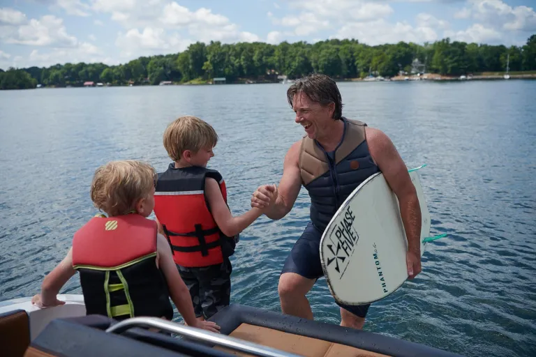 3 people about to surf