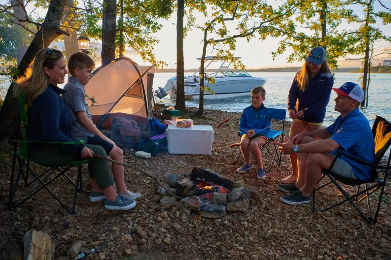 people around a campfire on shore