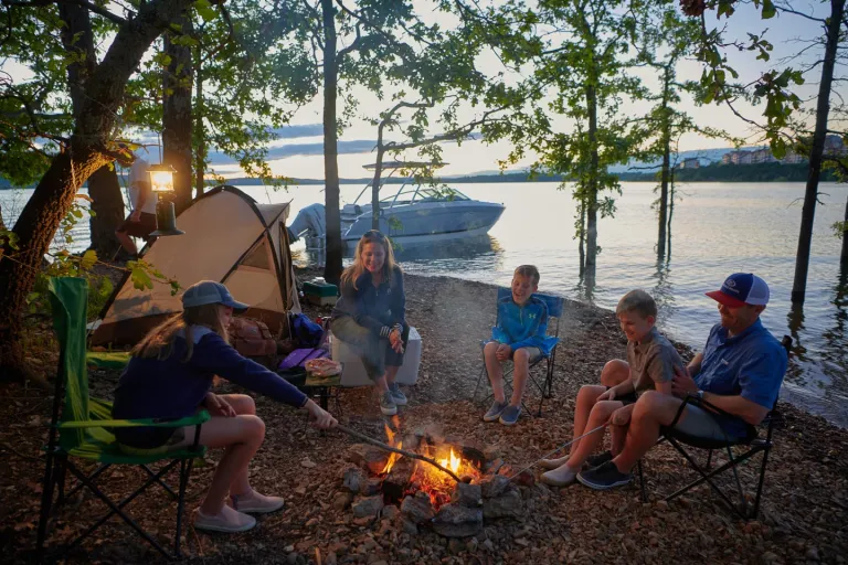 people around a campfire on shore