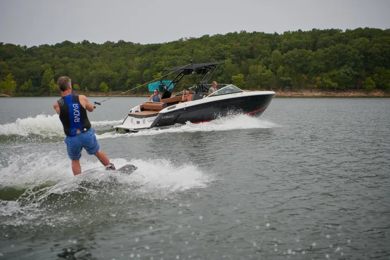 a person wakesurfing by a boat