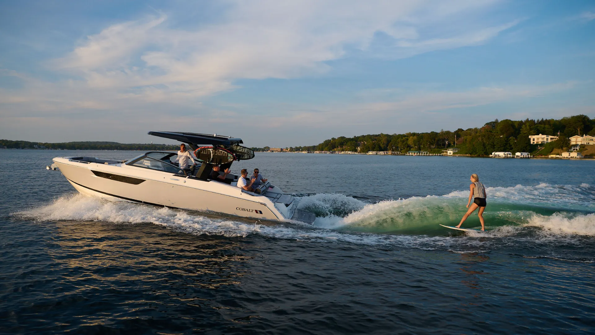 boat on water with a wakesurfer behind it