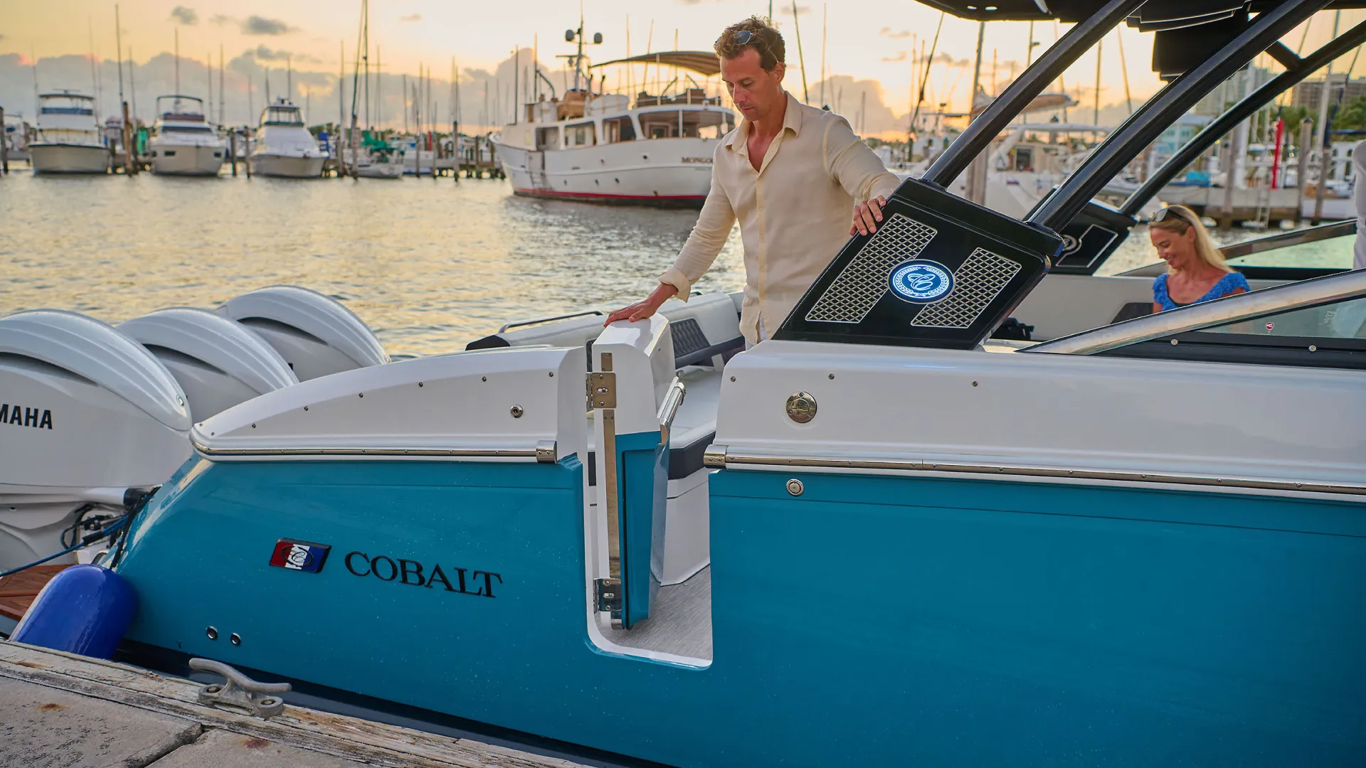 man stepping out of a boat onto a boardwalk