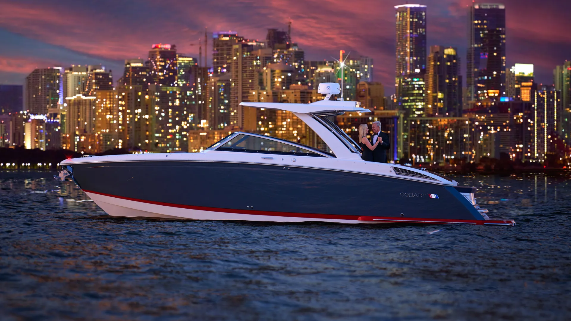 fancy couple on a boat during sunset