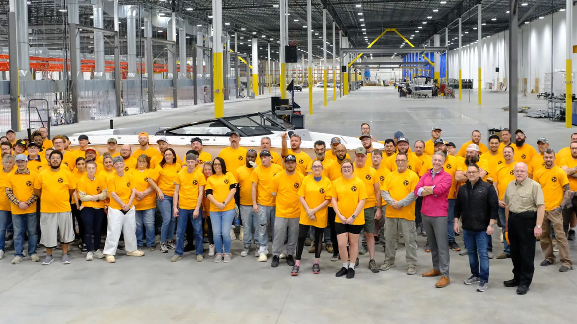 people in a warehouse taking a group photo